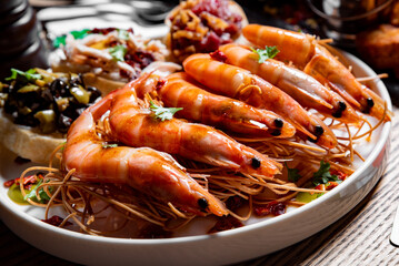 Whole fried big shrimps with seasonings in plate