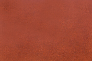 Painted surface of red-brown color with visible texture