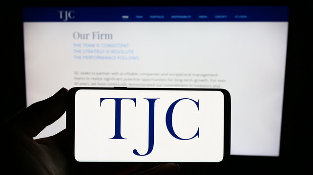Stuttgart, Germany - 09-07-2023: Person holding smartphone with logo of US investment business The Jordan Company (TJC) on screen in front of website. Focus on phone display.