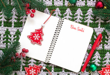 Fototapeta na wymiar Dear Santa. Letter to Santa Claus on a Christmas crochet background with wooden toys and fir tree branches. Flat lay. Copy space.