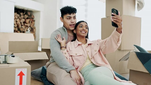 Happy couple, real estate and video call, social media or moving in new home together in live streaming. Excited man and woman relax with smile and boxes in online vlog, property or house renovation