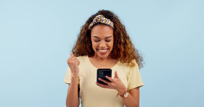 Phone, excited woman and surprise of winner dancing in studio for lottery, bonus or promotion. Smartphone, wow and happy person celebrate success of good news isolated on blue background mockup space
