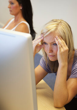A Young Woman Struggles To Understand As She Reads From Her Computer Screen; South Shields, Tyne And Wear, England