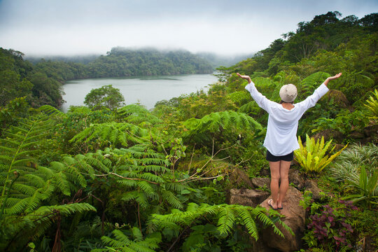 A Female Tourist Stands Among Tropical Plants That Grow Around The Twin Lakes At Twin Lakes National Park; Island Of Negros, Philippines