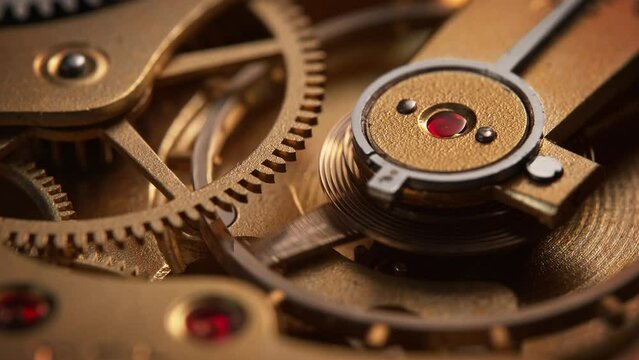 Old Rubies Jeweled Watch Mechanism with Golden Balance Wheel and Gears Moving in Slow Motion 