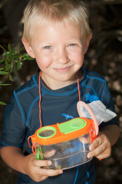 A Young Boy With A Bug Catcher; Lake Tahoe, California, United States of America
