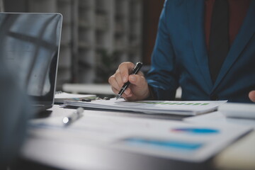 Obraz premium Financial Business team present. Business man hands hold documents with financial statistic stock photo, discussion, and analysis report data the charts and graphs. Finance Financial concept