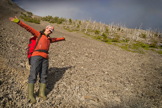 Female caver celebrating on a mountainside; Coleman alberta canada