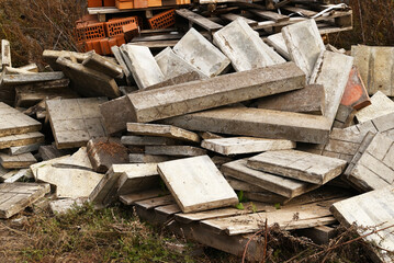 Construction waste. A pile of construction waste. Building rubble and stones. Abandoned garbage, junk, garbage piled up near the building. Street scene. Recycling industry. Ecology. Not Ecology.