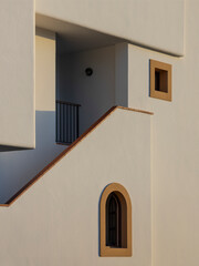 Mediterranean style white facade in warm sunset light.