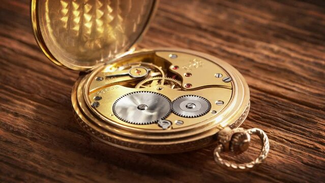 Vintage Golden Pocket Watch on a Wooden Board in the Sun Rays - Open Mechanism Works in Slow Motion