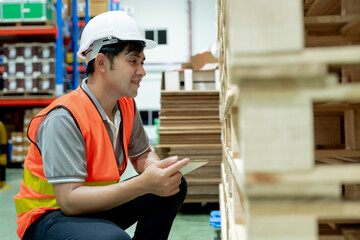 Asian male factory inspect pallet in warehouse or inventory and check stock product. Transport...