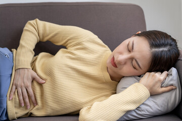 stomach ache. Asian women have abdominal pain, indigestion, gastritis, menstrual cramps,...