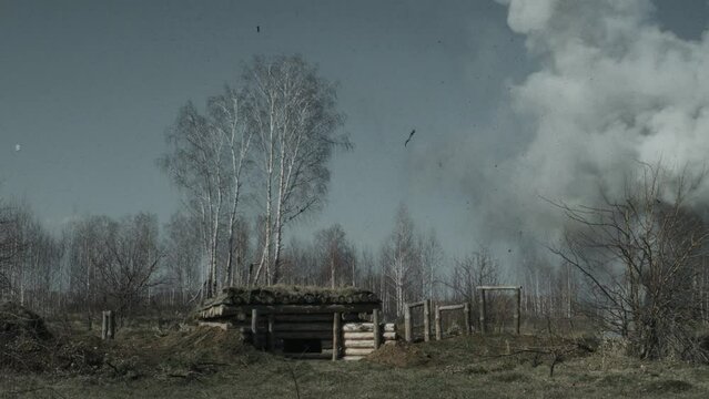Wide shot of military building bombarding process on battlefield during World War reenactment