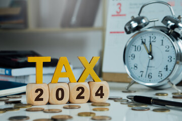Tax wooden letter and 2024 number on wooden block.Pay tax in 2024 years.Payment to government,...