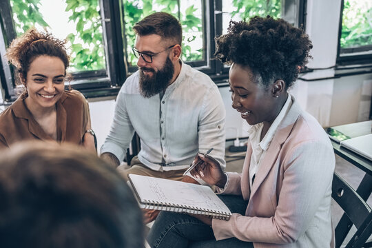 A diverse, casual design team collaborates in the office, creating innovative solutions and fostering in dynamic creative environment.	
