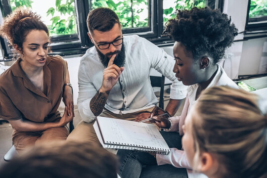 A diverse, casual design team collaborates in the office, creating innovative solutions and fostering in dynamic creative environment.	
