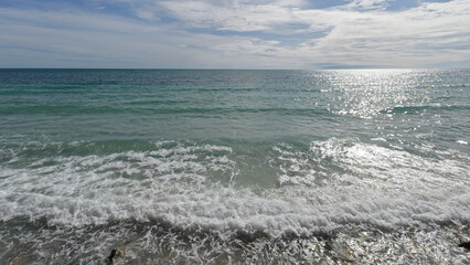 sea waves at sunset. sea waves crash on the rocks of the coast creating an explosion of water. Wave propagation.