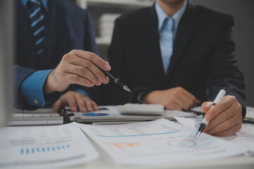 Fototapeta premium Financial analysts analyze business financial reports on a digital tablet planning investment project during a discussion at a meeting of corporate showing the results of their successful teamwork.