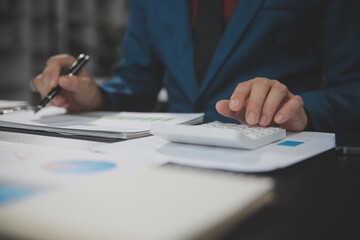 Financial Business team present. Business man hands hold documents with financial statistic stock photo, discussion, and analysis report data the charts and graphs. Finance Financial concept