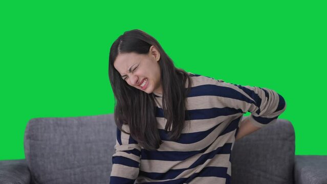 Sick Indian girl suffering from back pain Green screen