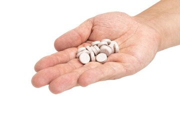 Round therapeutic pills or drugs for treatment in male hand palm isolated on transparent background, medicine and healthcare concept, close-up view