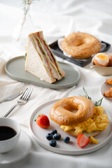Breakfast eggs berries and strawberry fruit on a white plate