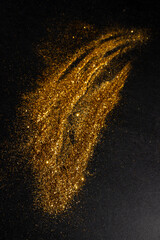 hand-drawn brush with golden material on a black background.