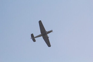 Small plane in the air. Blue sky with white clouds. High quality photo