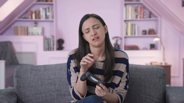 Tired Indian girl gamer playing video games