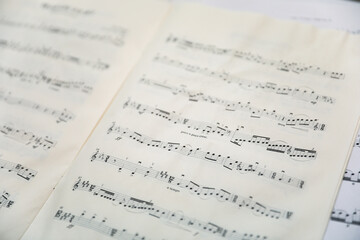 Sheet music notes on paper, artistic composition, musical harmony, creativity