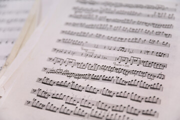 Sheet music notes on paper, artistic composition, musical harmony, creativity