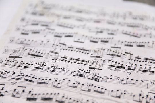 Sheet music notes on paper, artistic composition, musical harmony, creativity