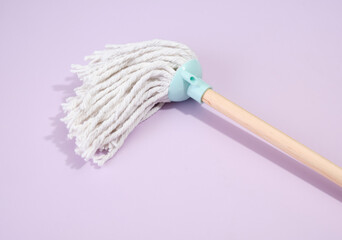 A mop, floor cleaner, floor wash on a purple background. Household equipment.