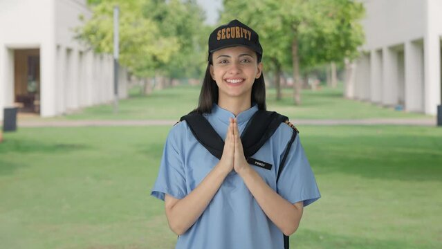 Happy Indian female security guard doing Namaste