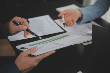 Financial Business team present. Business man hands hold documents with financial statistic stock photo, discussion, and analysis report data the charts and graphs. Finance Financial concept