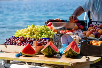 Foto op Plexiglas Watermelons, green and purple grapes, peaches in a boat in Croatia © kvitkanastroyu