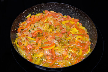 Colorful vegetable sauce or dish in cooking pan.