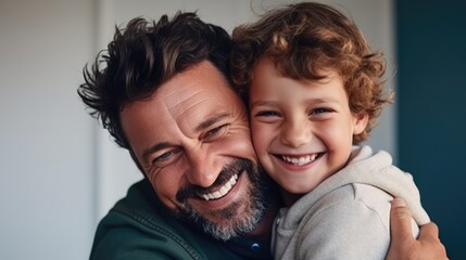Portrait of happy father and smiling son embracing together.