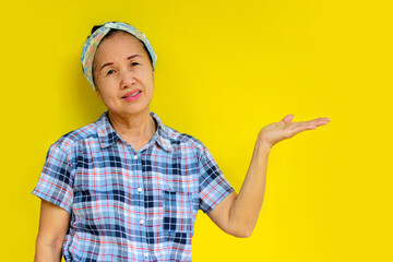 Asian woman Raise your hand to place the product. Health food, cream, and other products.Isolated on yellow background.