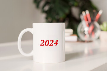 Mug with word 2024 concept. Office background