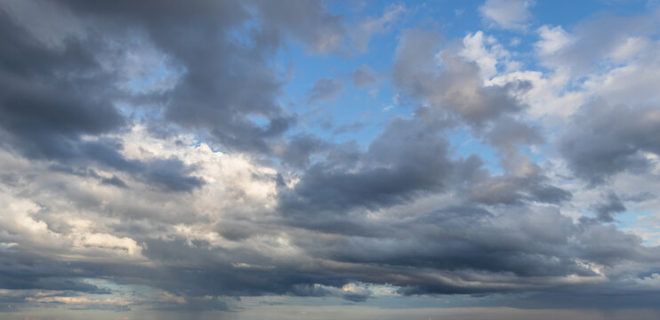 Sky replacement dramatic dark gray and white storm clouds with blue sky panoramic wide view