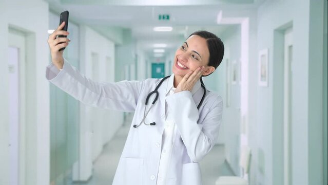 Happy Indian female doctor clicking selfies