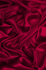 Rich and luxury red silk fabric texture background.