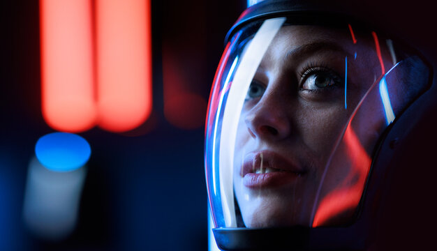 Astronaut in futuristic costume. Girl in glasses of virtual reality while touching air. Augmented reality game, future technology, AI concept. Dark background.