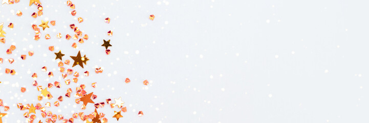 Banner with golden stars and crystals confetti on a blue background. Selective focus.