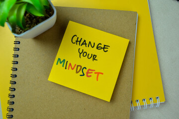 Concept of Change Your Mindset write on sticky notes isolated on Wooden Table.