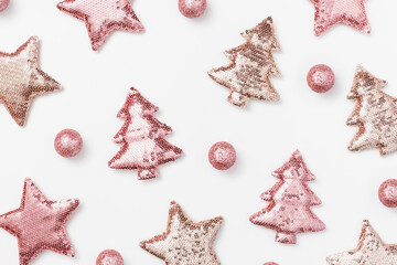 Christmas holiday pink decorations trend sparkling xmas toys from metallic sequins, shining Christmas trees and stars. New Year background as aesthetic pattern. Happy holidays concept