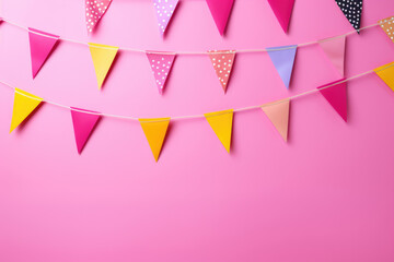 Decorative colorful pennants for birthday on a pink background