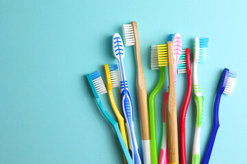 Different toothbrushes on a colored background. Dental care, oral health.